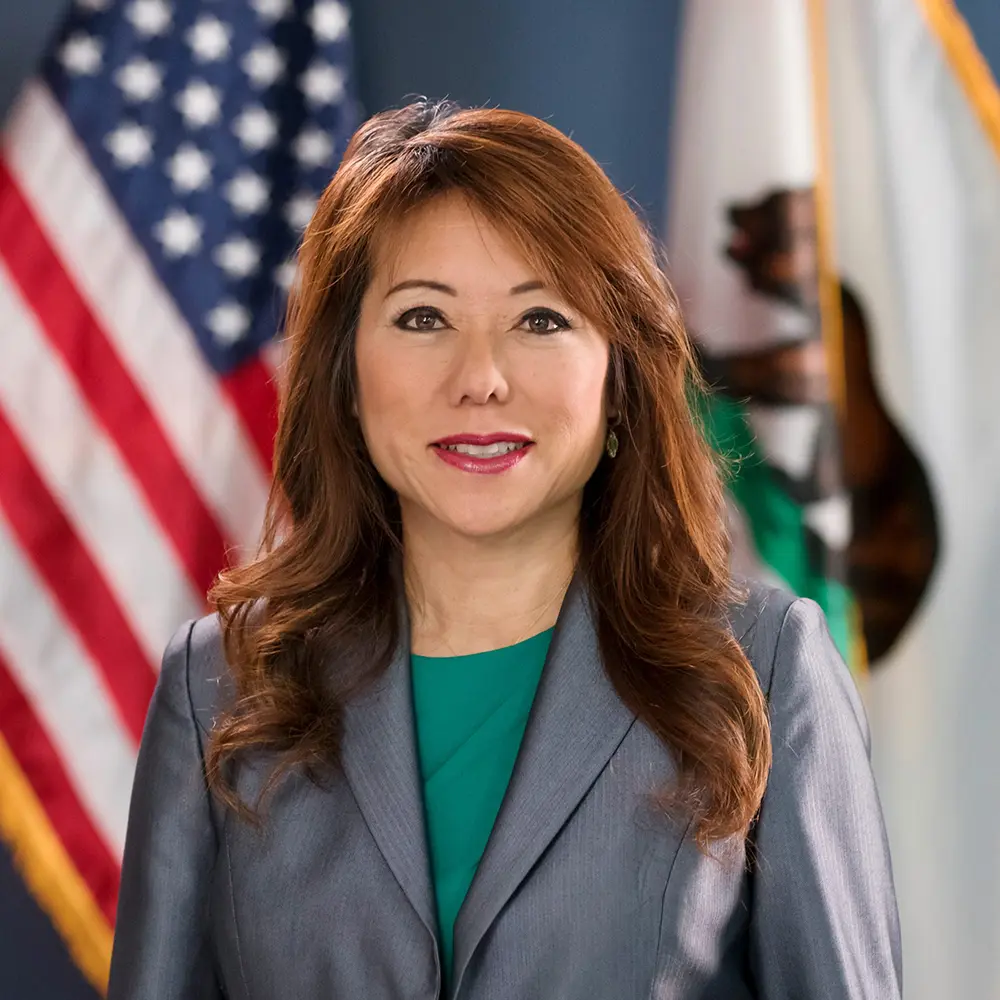 California State Treasurer Fiona Ma with an American flag behind her