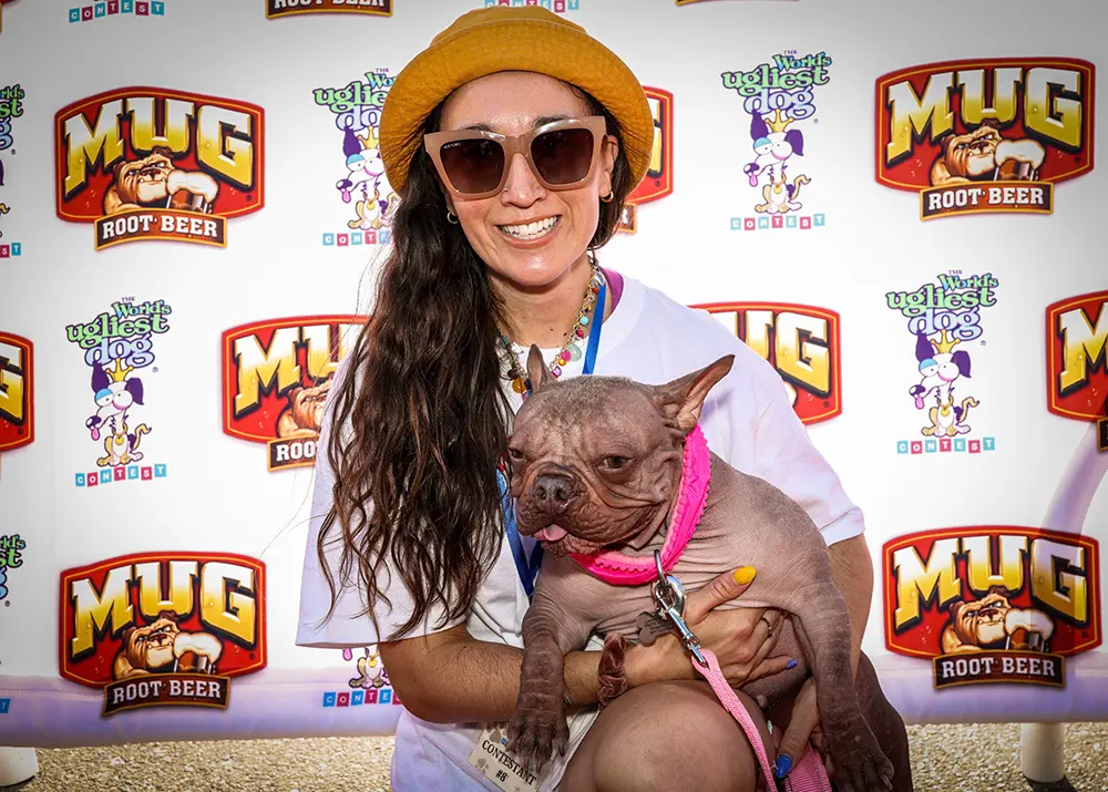 World's Ugliest Dog® 2025 first place winner Petunia and her owner